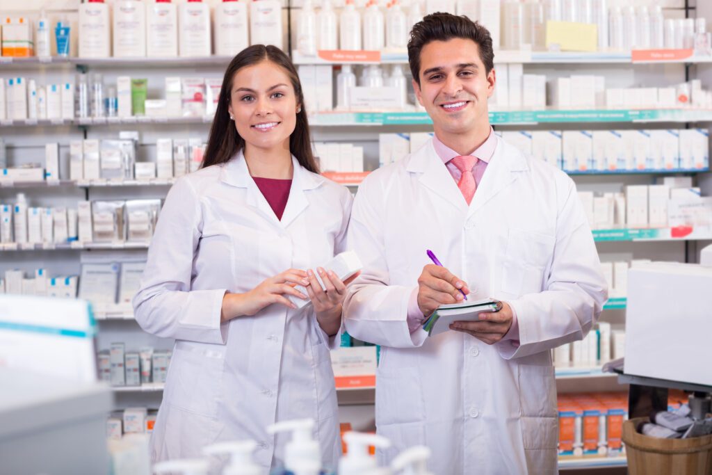 Smiling pharmacist and pharmacy technician